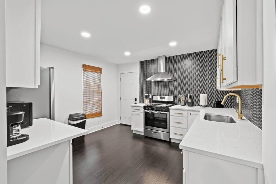 Bright, modern kitchen with sleek gas stove, oven, fridge, and dishwasher. Includes handy coffee pot, toaster, and electric kettle. Equipped with essentials, fire extinguisher & first aid kit. 