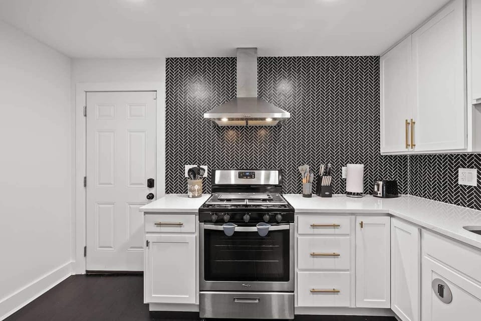 Modern, fully equipped kitchen with a gas stove and oven, microwave, refrigerator/freezer, and dishwasher. Enjoy cooking with ample counter space plus a coffee pot, toaster, and electric tea kettle for easy mornings.