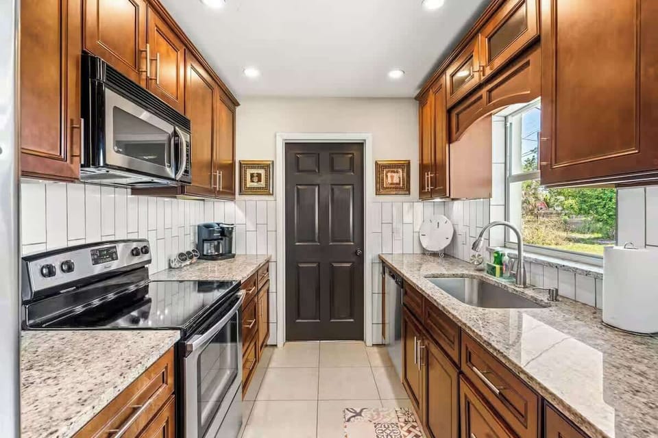 Modern kitchen with granite countertops and stainless steel appliances.