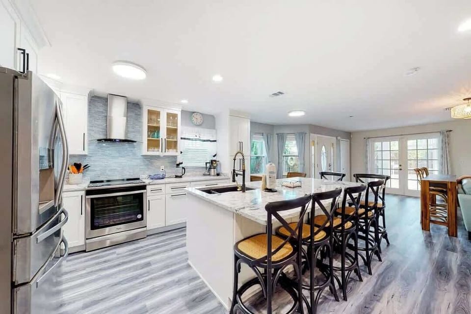 Modern kitchen with marble island and seating for five