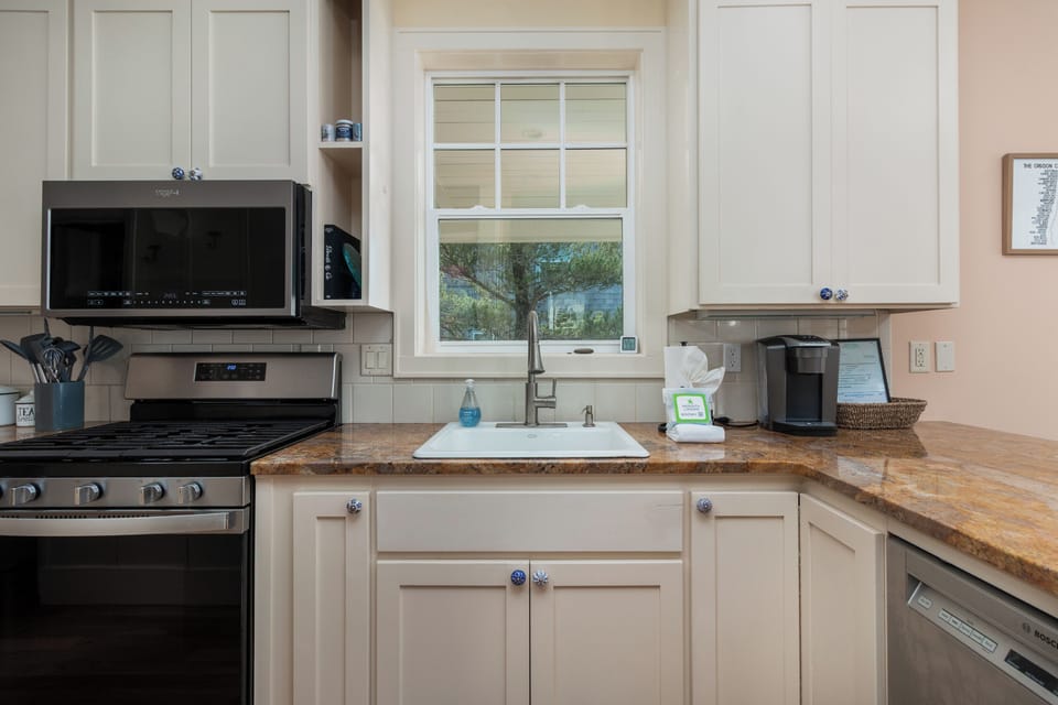 Your fully equipped kitchen awaits with granite counters, modern appliances, and morning coffee station ready for leisurely breakfasts.