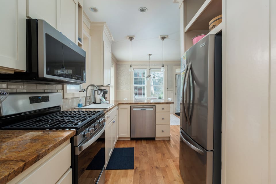 Your fully equipped kitchen features stainless steel appliances, granite counters, and warm hardwood floors—perfect for preparing memorable meals.