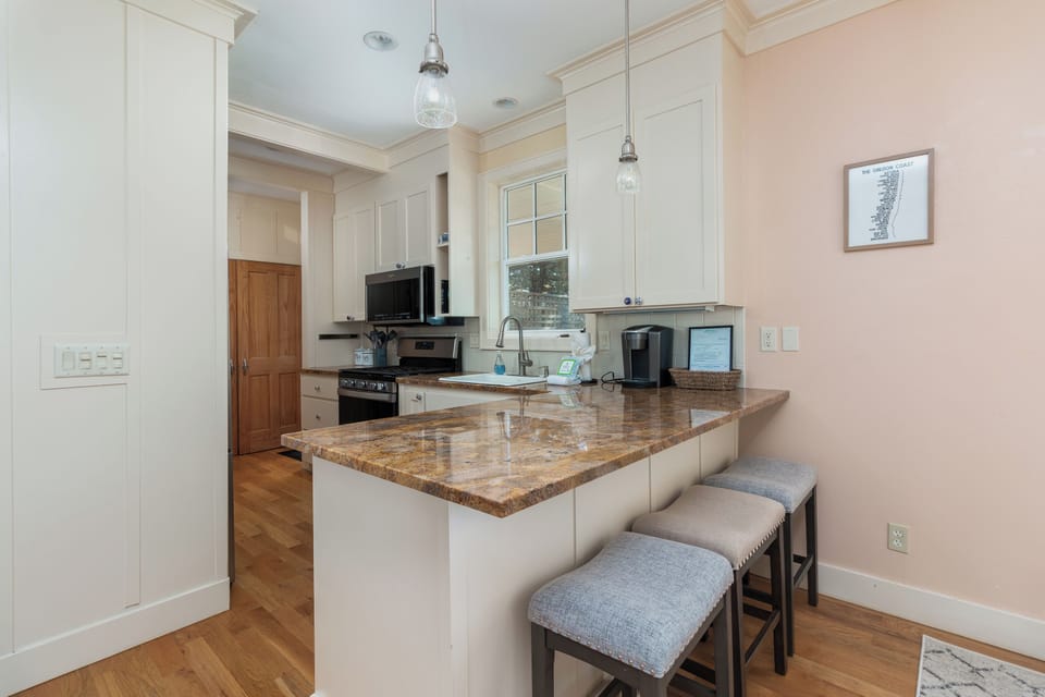 Your fully equipped kitchen features granite countertops, modern appliances, and a convenient breakfast bar where you can enjoy morning coffee together.