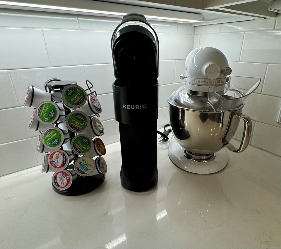 Keurig with coffees and creamers and sweeteners 