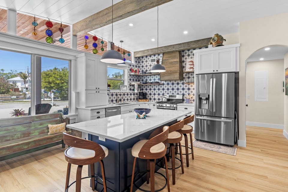 Cook and gather around your stunning kitchen island featuring marble countertops, stainless steel appliances, and artistic tilework.