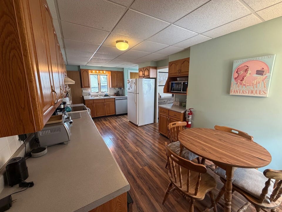Your spacious kitchen comes fully equipped with everything you need for memorable meals together—from morning coffee to family dinners around the warm wooden table.