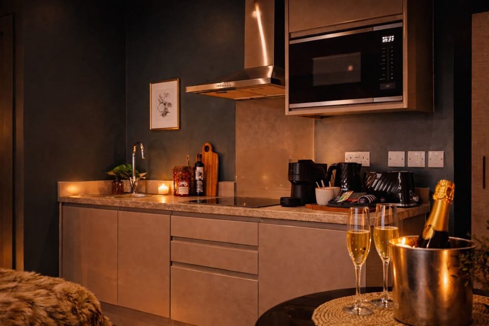 Fully equipped kitchen with hob, microwave, fridge-freezer, dishwasher, and washing machine — everything you need for short or extended stays