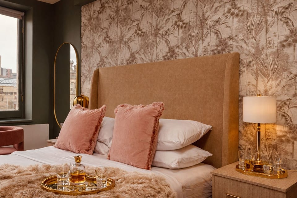 Thoughtful touches throughout — crisp linens, plush pillows, and bedside USB charging for your convenience