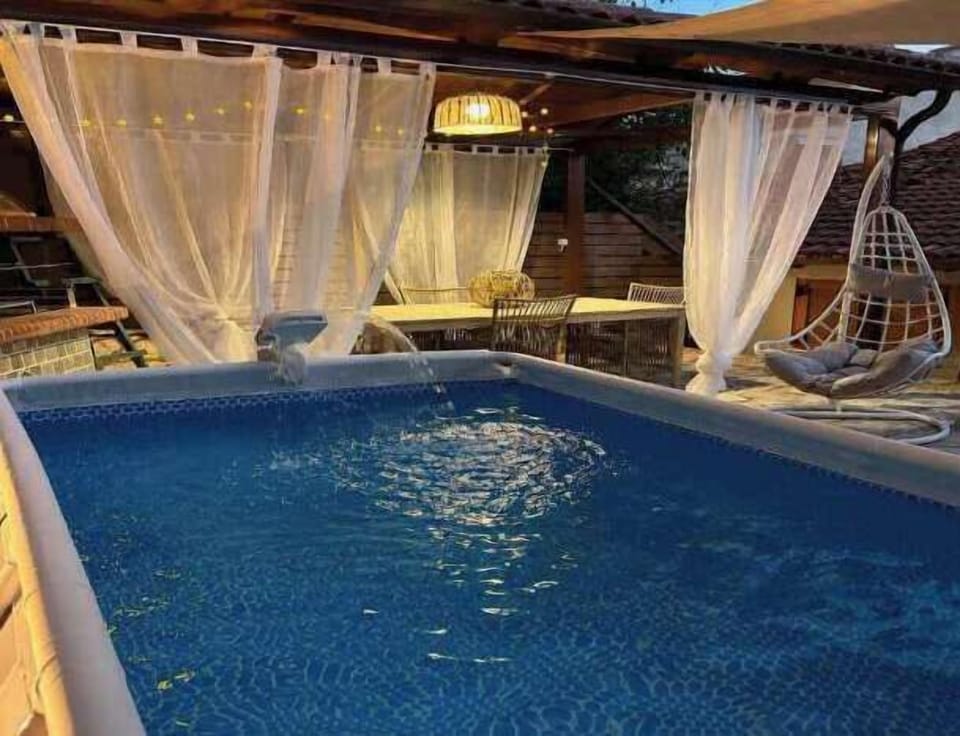Cool off in your private plunge pool, then unwind beneath the softly lit pergola for the perfect evening.