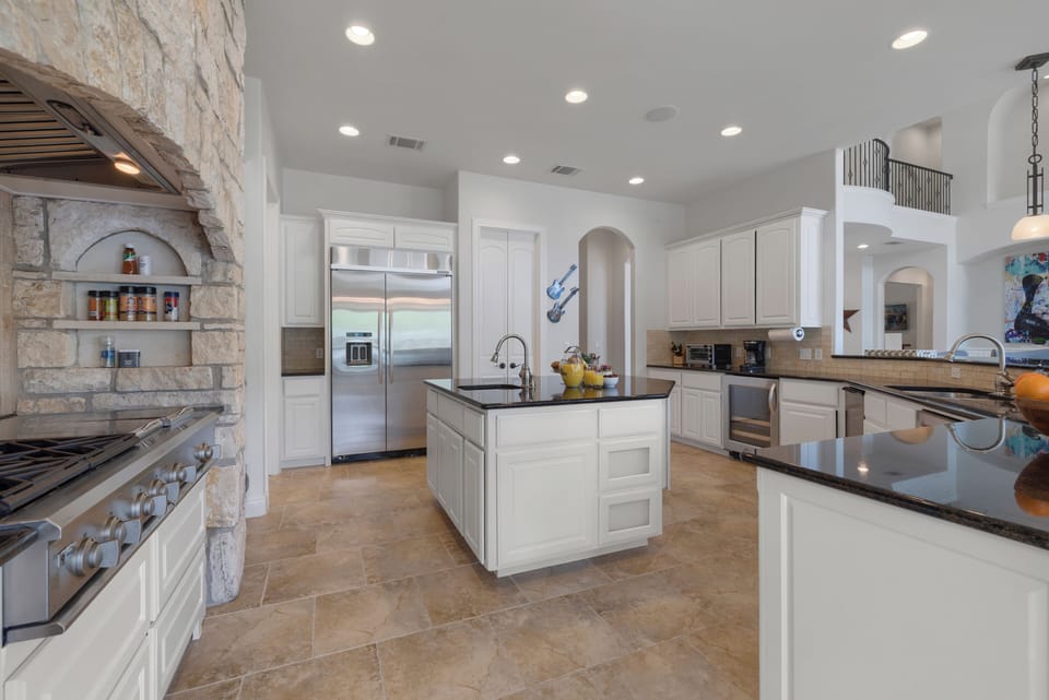 Bright island kitchen with lake views and Austin character