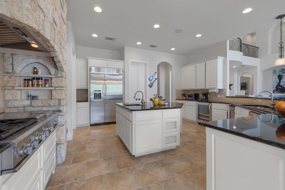Bright island kitchen with lake views and Austin character