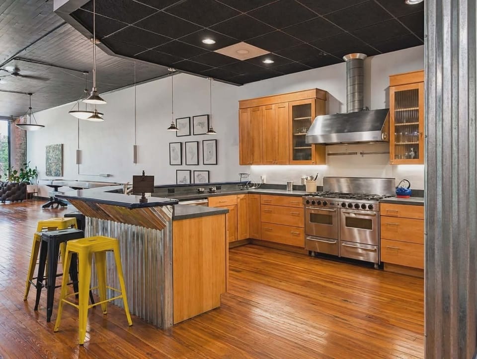 Large kitchen with dishwasher and gas range.