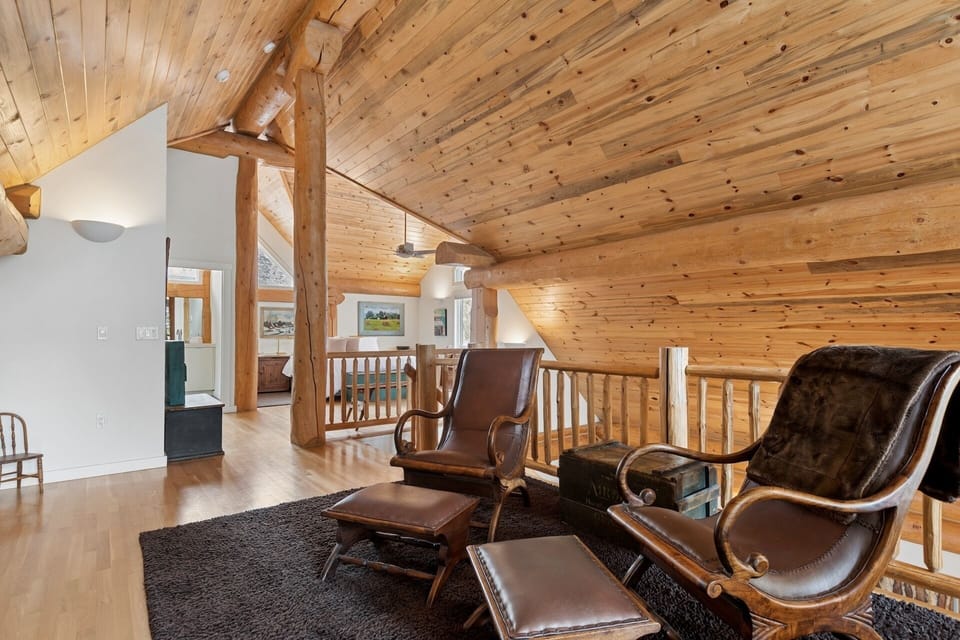 Unwind in your cozy loft lounge with exposed beams and leather seating perfect for evening relaxation.