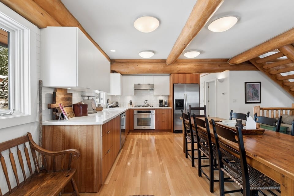 Gather around this stunning open kitchen with soaring timber beams and modern appliances for memorable meals together.