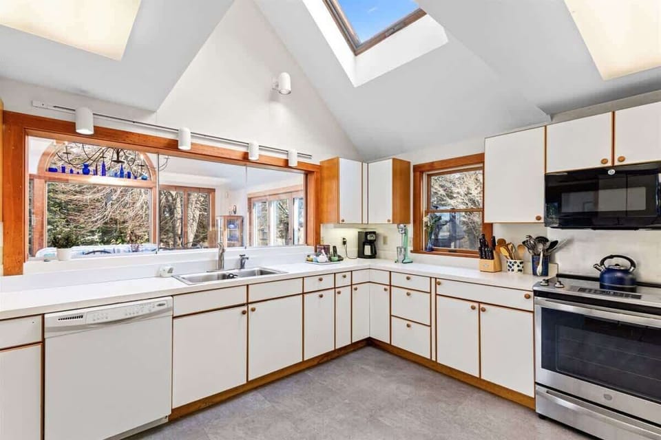 Sliding glass opens the kitchen up to the dining room
