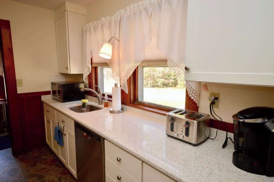 Full kitchen with coffee maker, toaster, dishwasher and microwave
