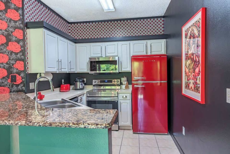 Gather with family and friends in this vibrant kitchen, perfect for cooking, sharing laughs, and creating unforgettable moments together.
