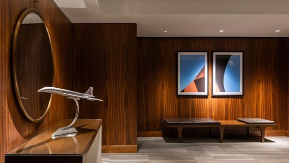 Stroll through art-lined corridors with warm wood and soft lighting.