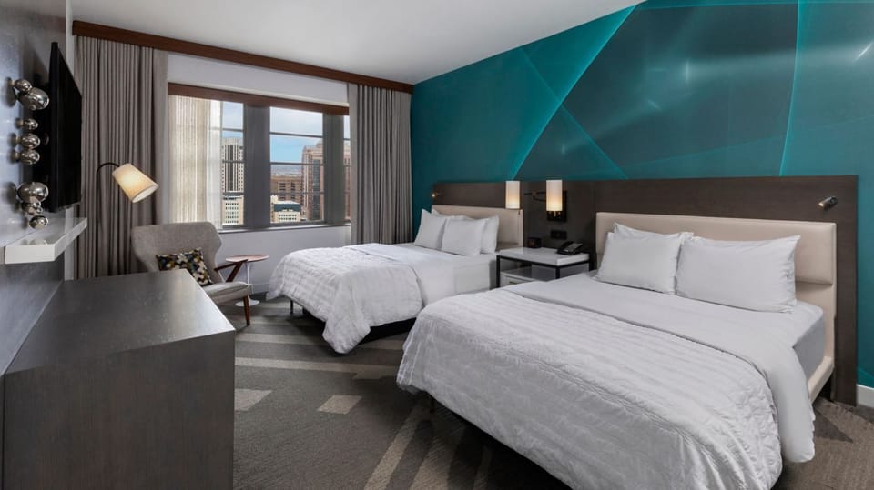 Unwind in crisp twin beds beneath a bold feature wall