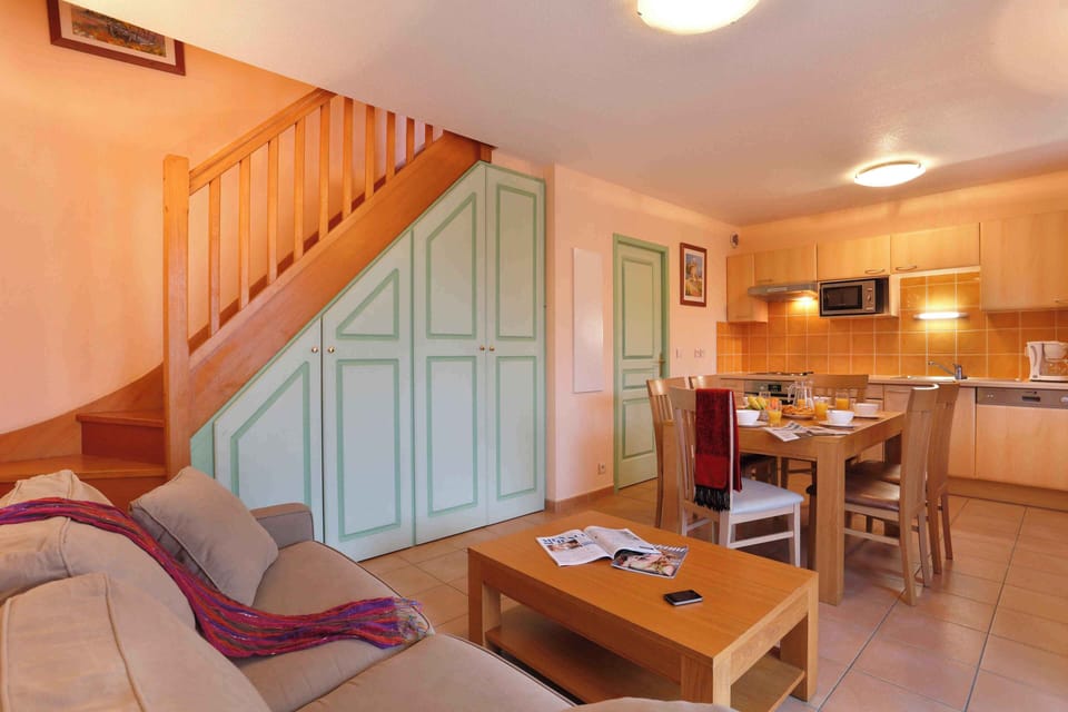 Double sofa bed in the living area sleeps two extra guests, with TV and direct access to the terrace