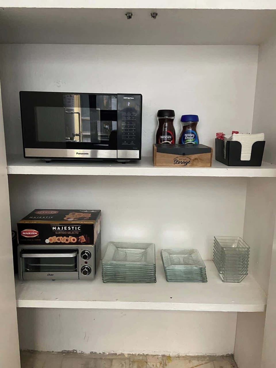 Microwave, toaster oven, and essential dishware provided for easy meals.