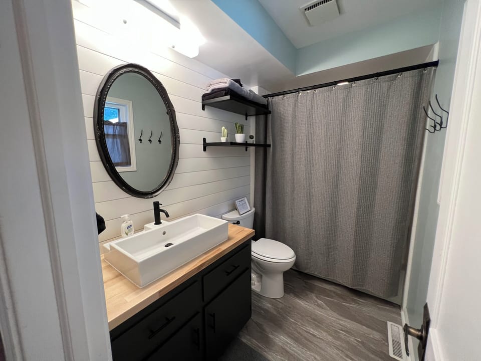 Full bathroom with tub shower.