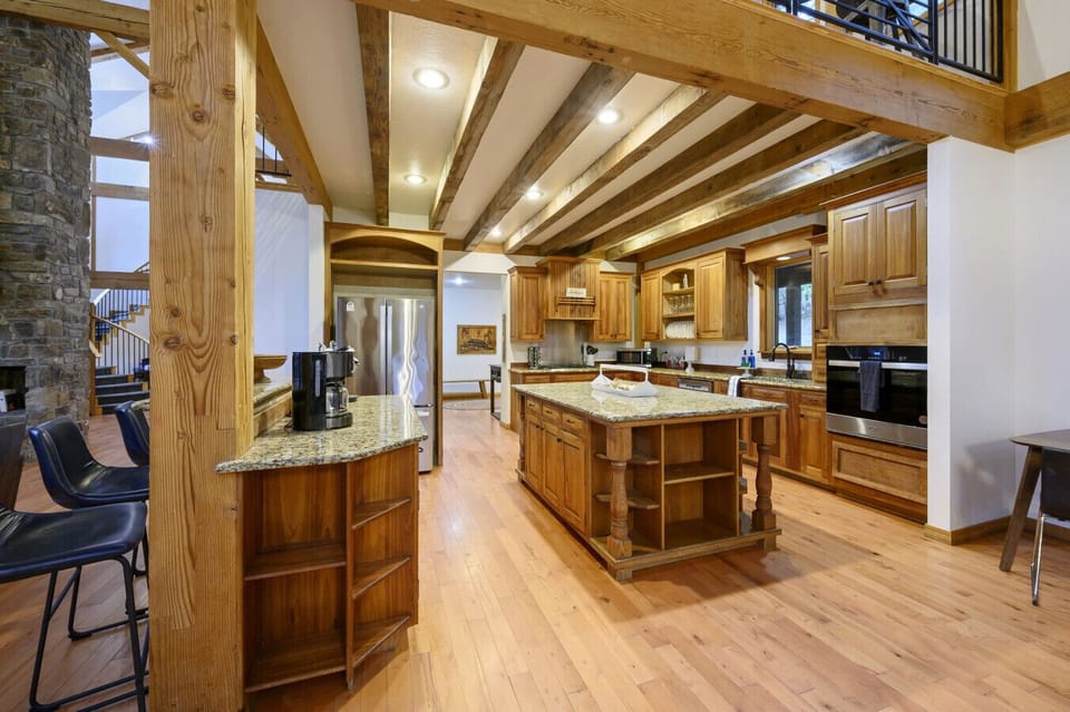 A massive granite island serves as the heart of the lodge`s chef-inspired kitchen.