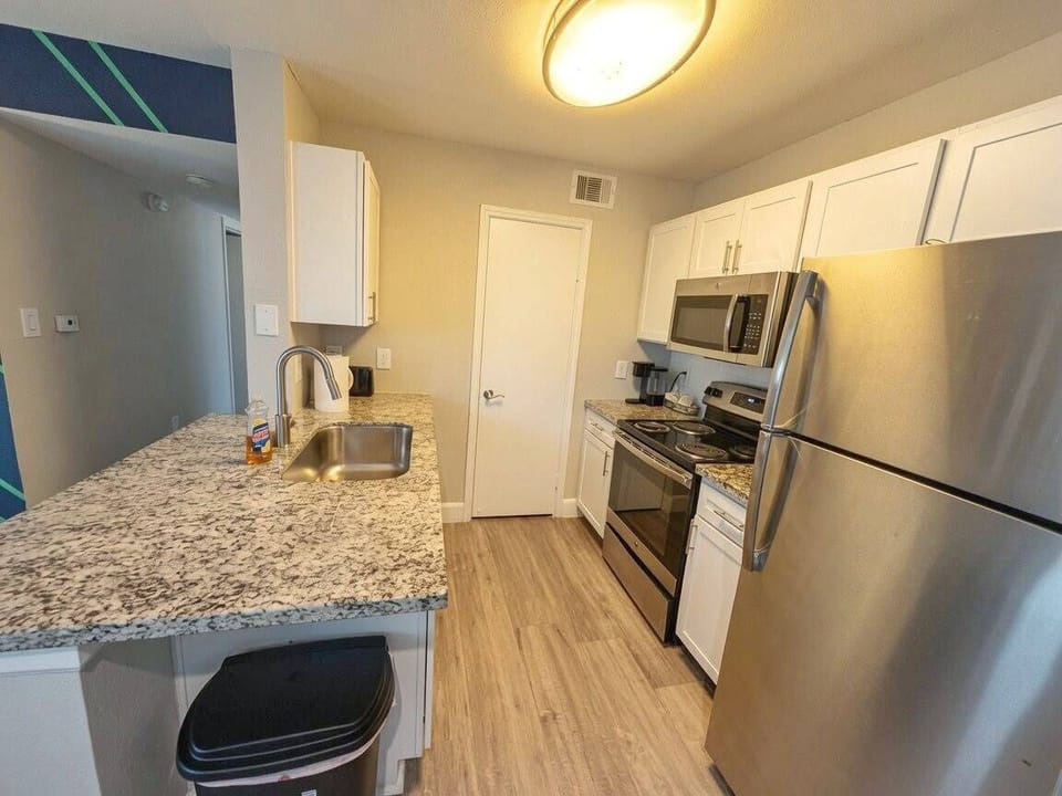 Modern kitchen with granite counters and stainless steel appliances