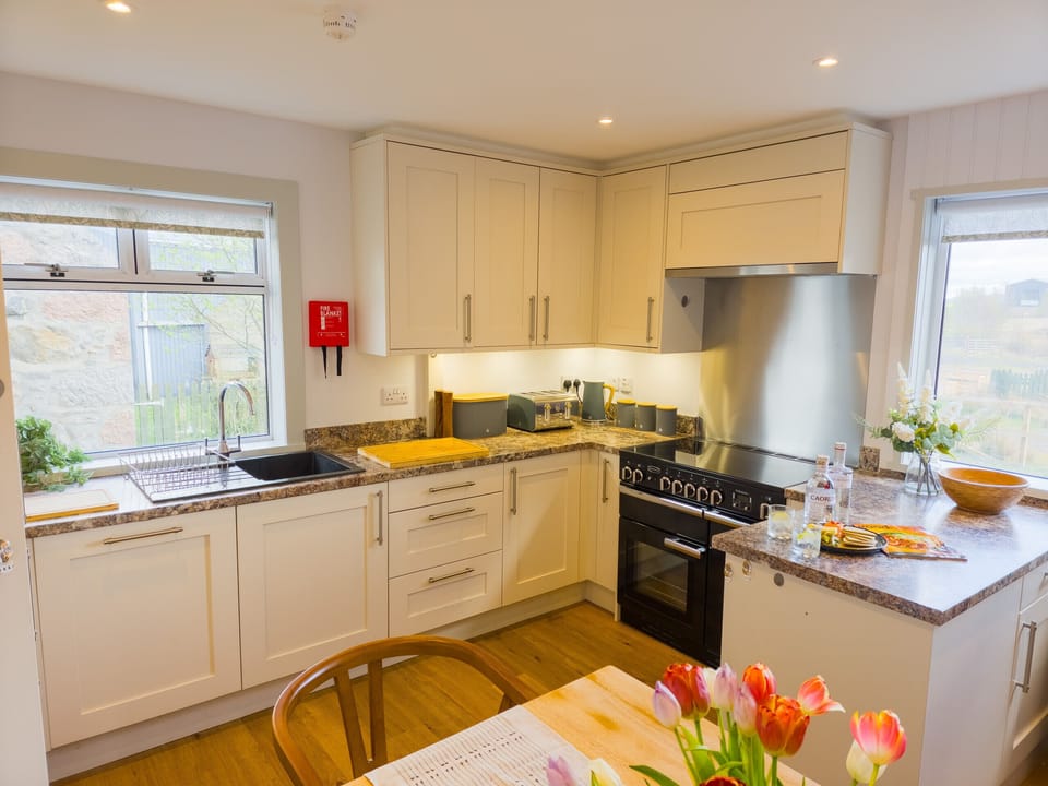 Spacious kitchen with range cooker — well-equipped for home cooking.
