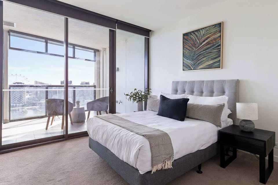 The master bedroom with a queen sized bed & plush pillows.