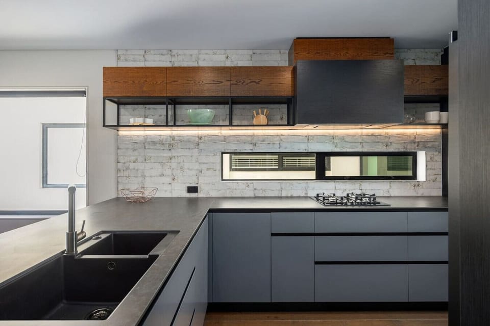 Fully equipped kitchen with bar seating, gas cooktop, oven, fridge freezer and dishwasher