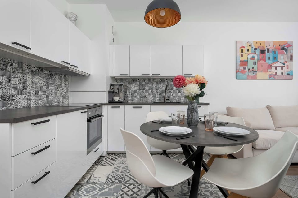 The sleek design of the kitchenette blending seamlessly with the living area.