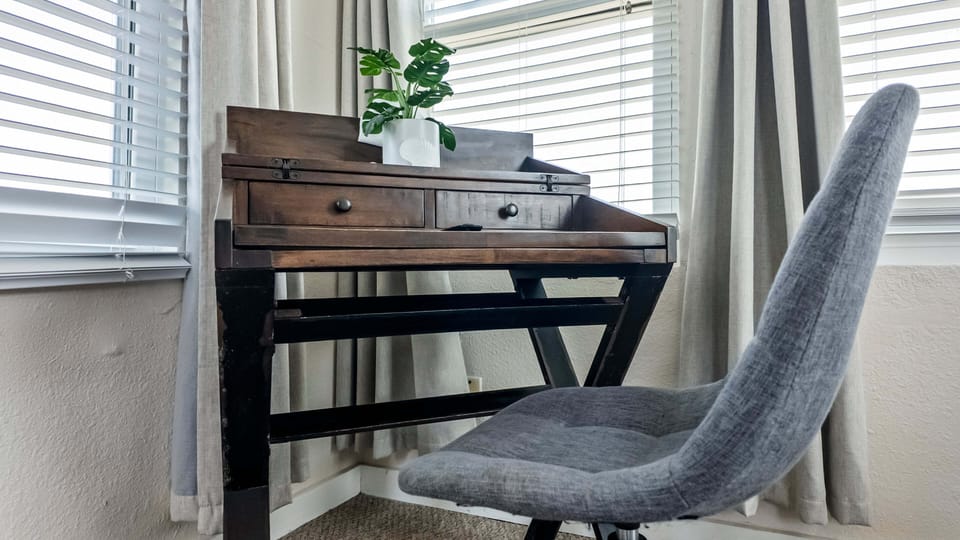 Dedicated workspace with desk, chair, and natural lighting for remote work during relaxing beachfront getaways in Galveston.