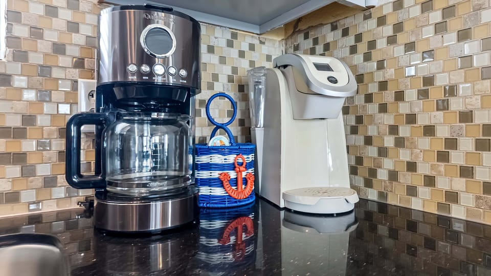 Kitchen coffee station featuring coffee maker and countertop appliances, perfect for starting mornings during your beach getaway.