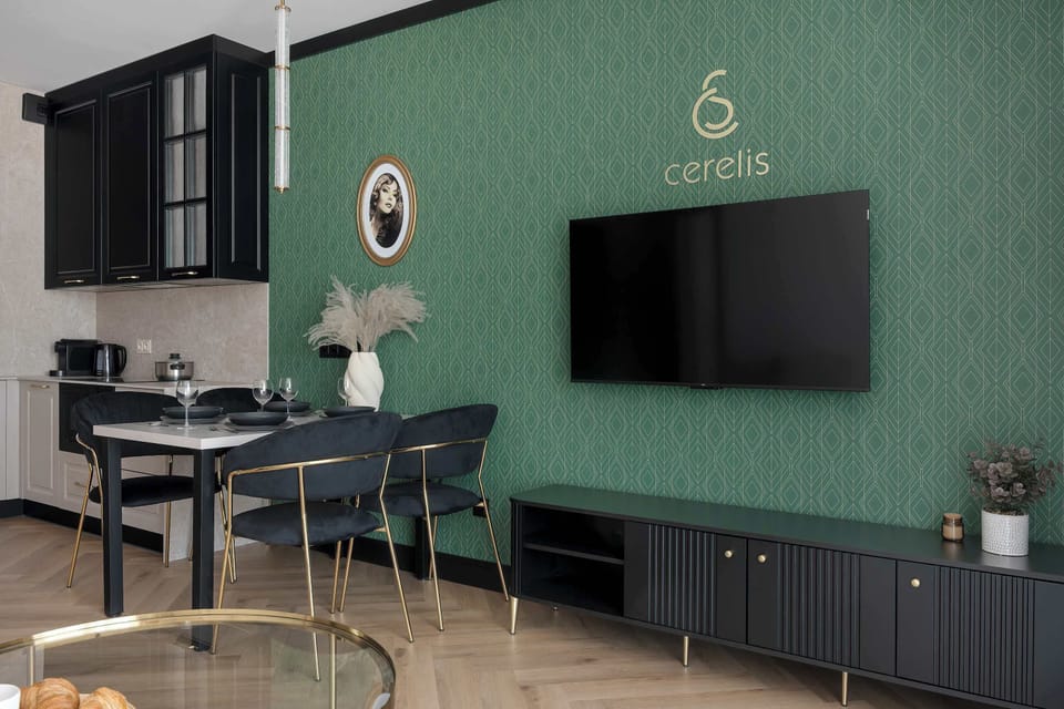 A decorative wall in the dining area is adorned with a stylish logo and a minimalist clock, adding a branded touch to the interior.