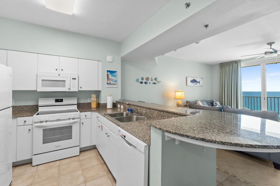 We have a full kitchen with marble counter top, cabinets, refrigerator, stove, microwave, dishwasher, and more!