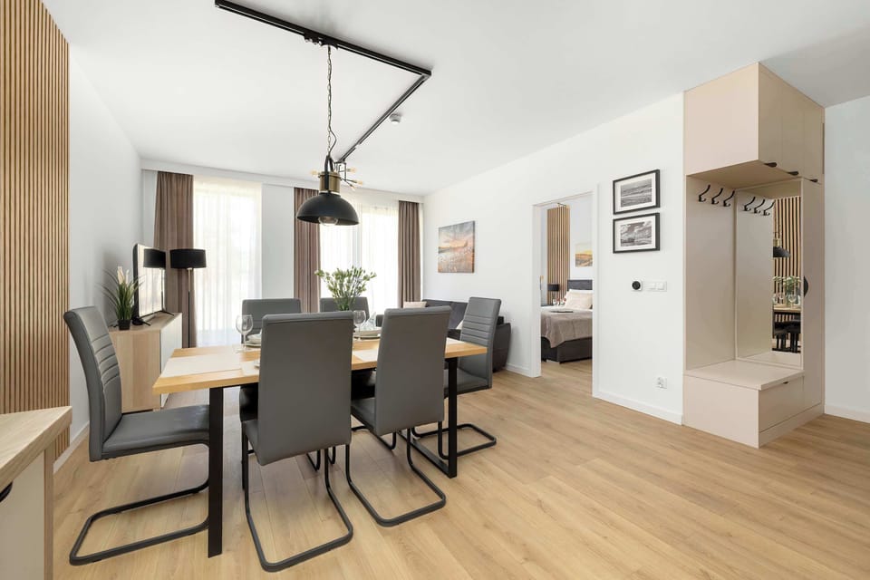 A dining space with a table and chairs positioned near the living area and kitchen.