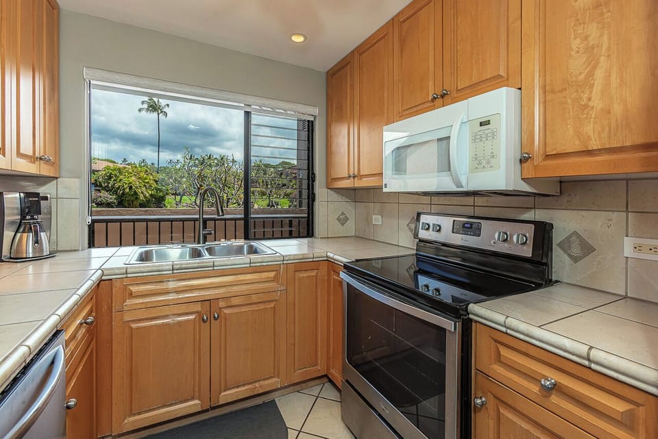 Cook your favorite meals in this well-appointed kitchen while enjoying tropical views through the window.