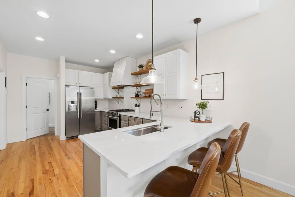 Bright, modern kitchen with sleek countertops and stylish seating.
