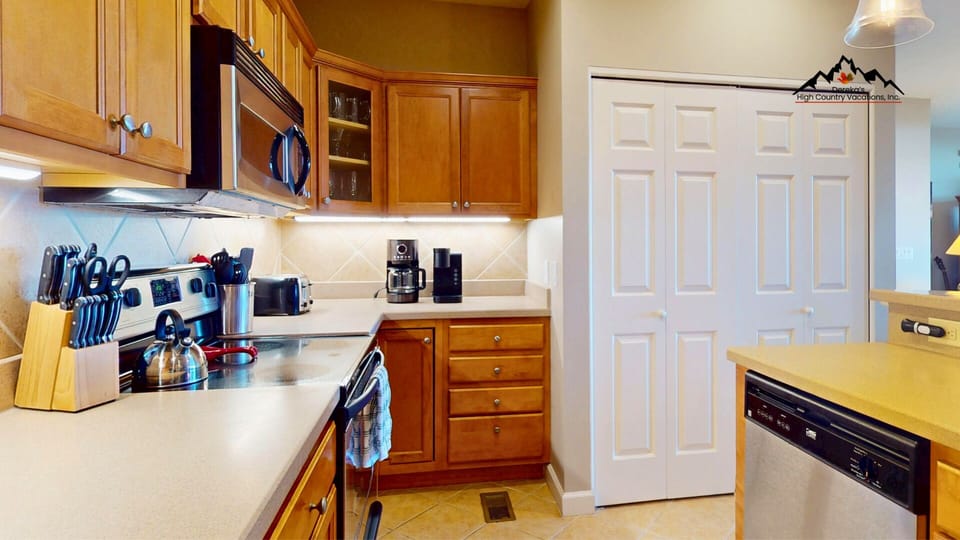 Your fully equipped kitchen awaits with warm wood cabinets, ample counter space, and everything you need to create memorable meals during your stay.
