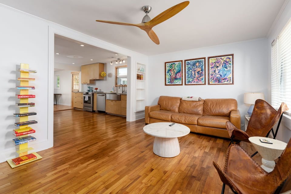 Settle into rich leather seating while warm wood floors and vibrant art create your perfect retreat sanctuary.