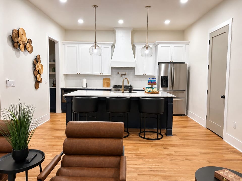 Luxury chef’s kitchen with oversized island, premium stainless appliances 
