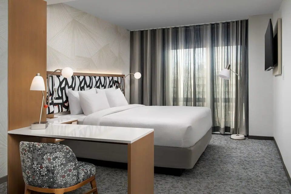 Unwind in a bright, modern room with plush bedding.