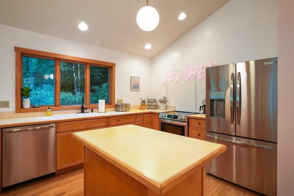 Kitchen: Bright space with modern appliances and serene forest views waiting for your culinary adventures!