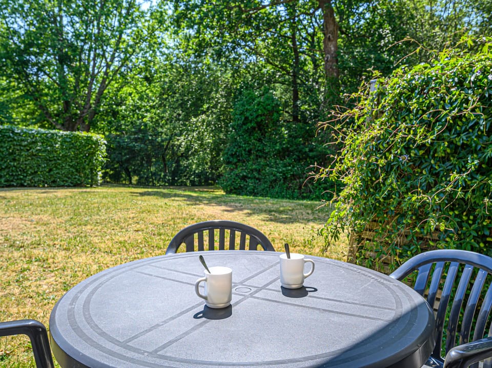 Picture sunny afternoons at the round table, drinks in hand, under the dappled shade of the trees.