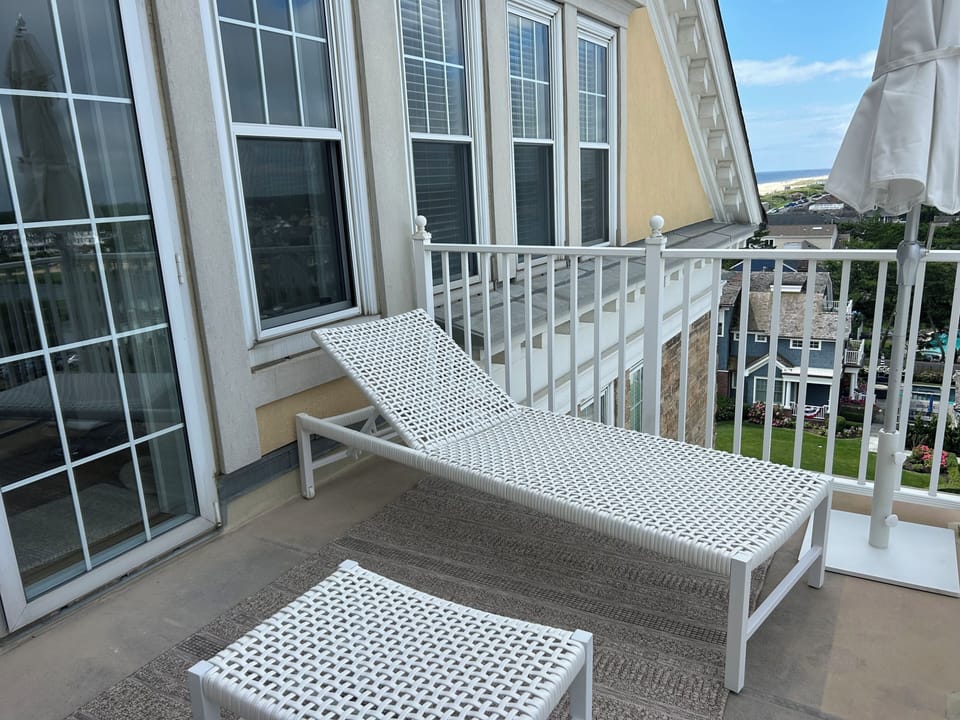 New market umbrella and outdoor furniture featuring a lounge chair sofa  ottoman