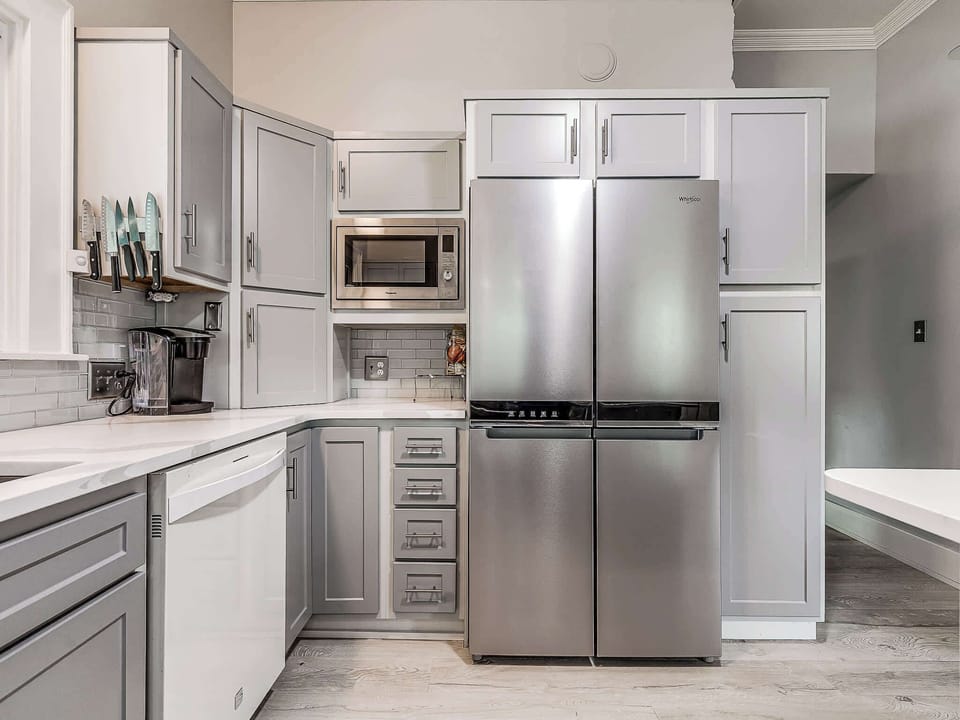 Convenience at your fingertips! The fully-equipped kitchen includes a large stainless steel refrigerator, microwave, and dishwasher, ensuring a seamless and comfortable stay for your group.