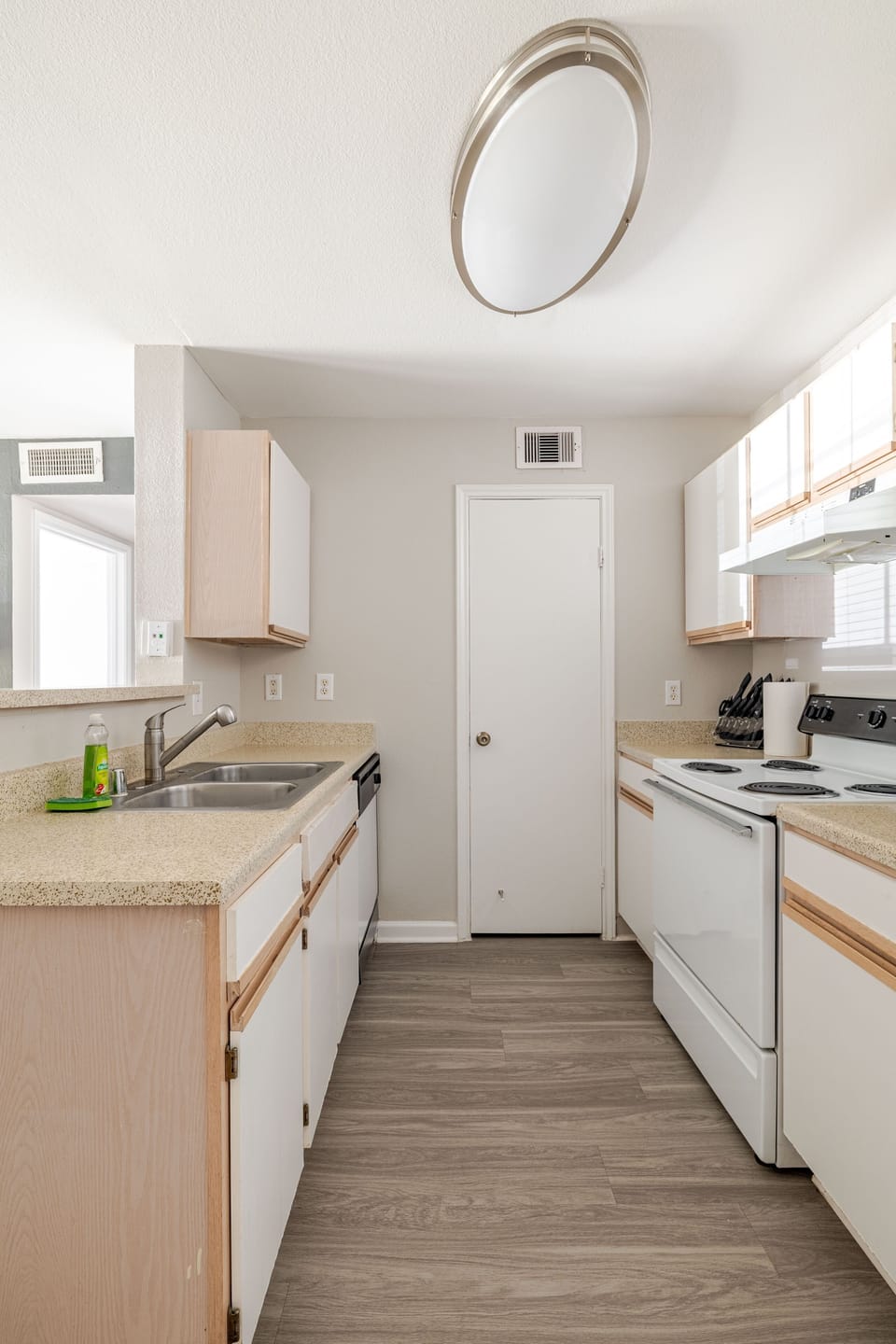 Bright galley kitchen with full-size appliances and generous counter space