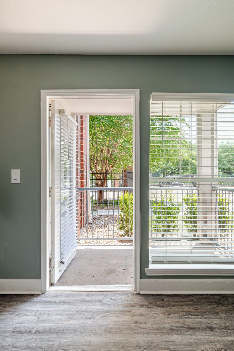 Bright living space with patio access and peaceful garden views