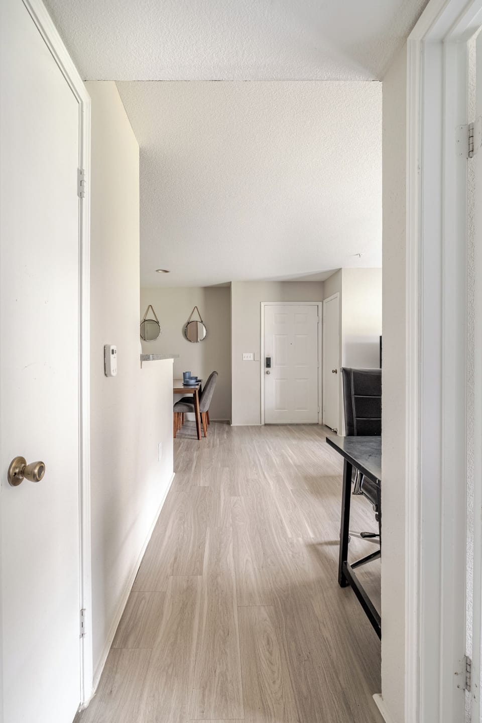 Bright entry hall with airy ceilings and modern wood-look flooring